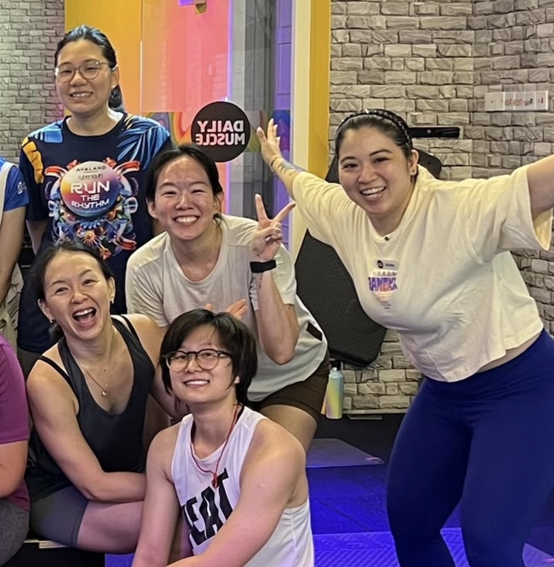 Members smiling together during a group class at DailyMuscle LightHouse